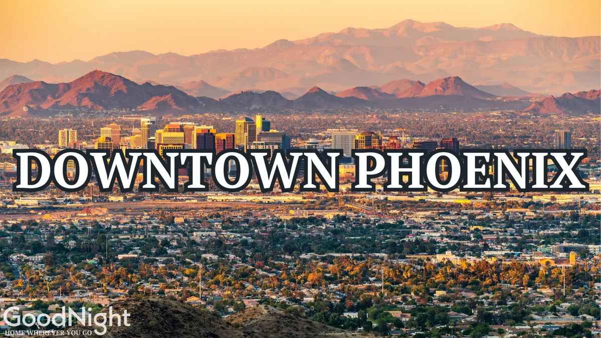 This view showcases the Downtown Phoenix skyline framed by surrounding mountains and the wide urban landscape. The vibrant cityscape represents the business district and the opportunities for commerce, networking, and exploration.