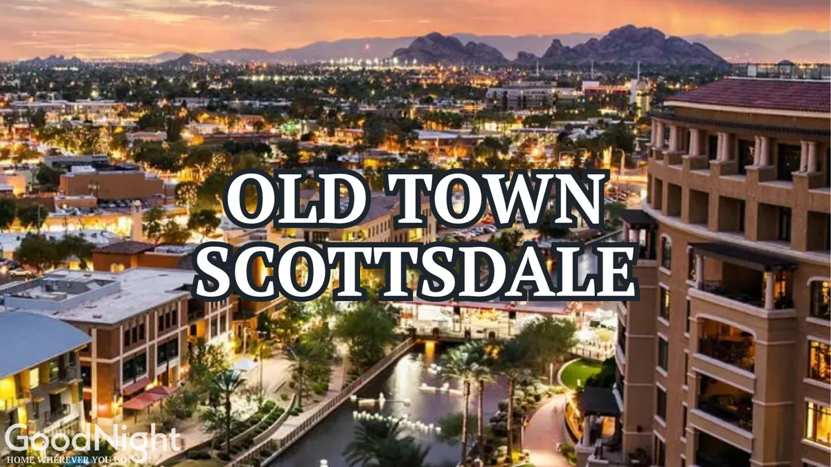 The iconic 'Old Town Scottsdale' sign arches over a lively waterway, framed by cafes, boutiques, and a mountainous backdrop. The atmosphere is welcoming and energetic, hinting at cultural events and nightlife that beckon couples and groups to explore.