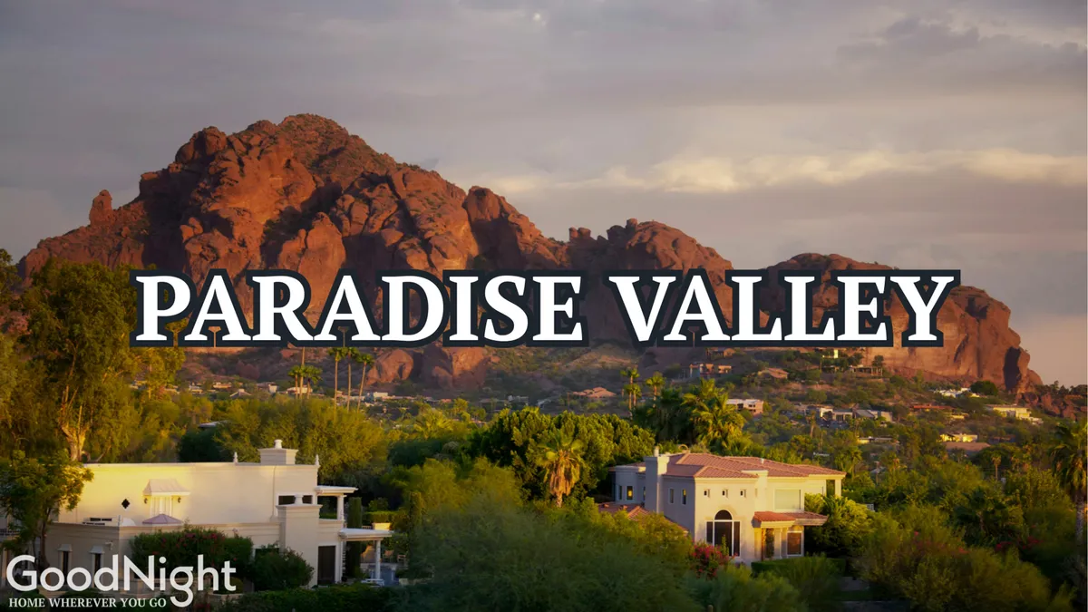 A panoramic view showcasing a mountain range in the distance, surrounded by lush greenery and residential homes. The scene evokes a tranquil and active outdoor lifestyle, with plenty of space for hiking and other outdoor activities.